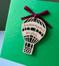 Blank card with detachable wooden 'Anniversary wishes' balloon decoration