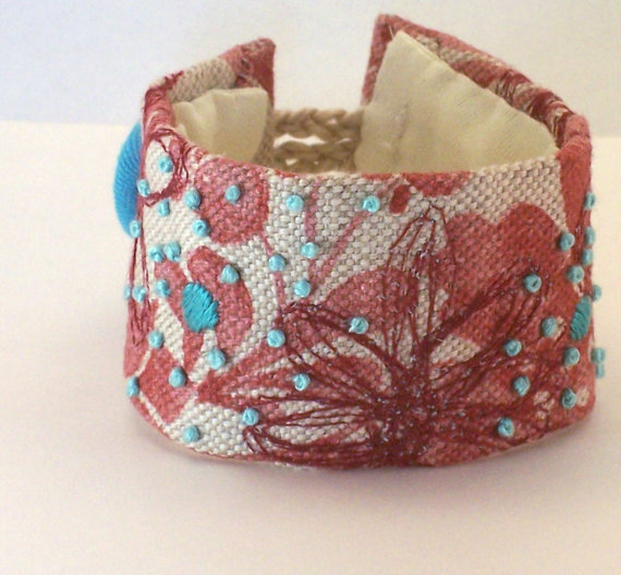 Hand stitched linen cuff in rust with turquoise embroidery