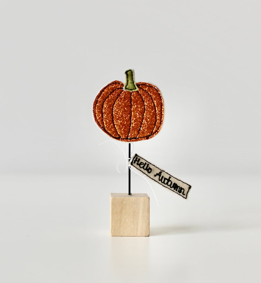 A Glittery Pumpkin with a Wire Stem & Wooden Block Stand