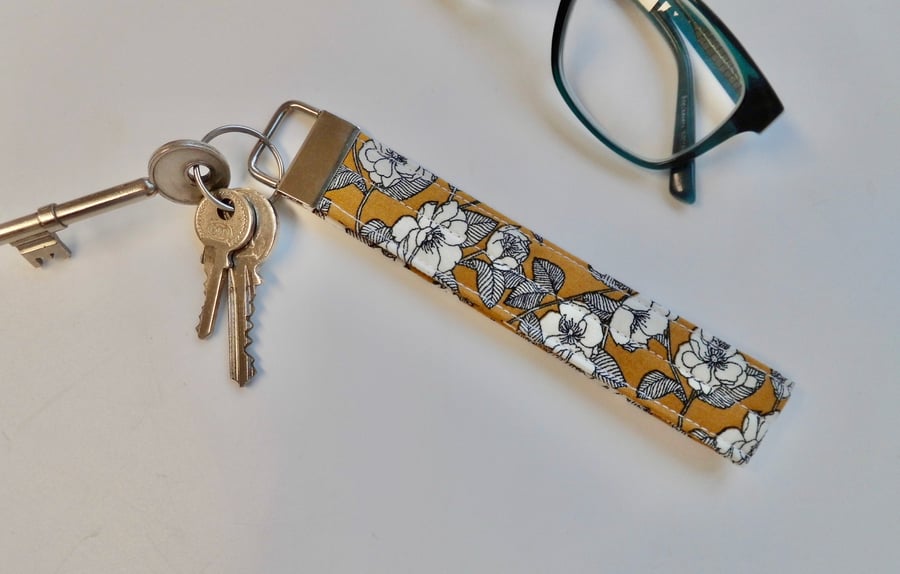 Key ring wrist strap in mustard ochre floral fabric 