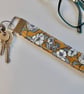Key ring wrist strap in mustard ochre floral fabric 