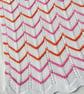 Orange, pink, and white striped baby blanket in cotton mix yarn  - Image 4