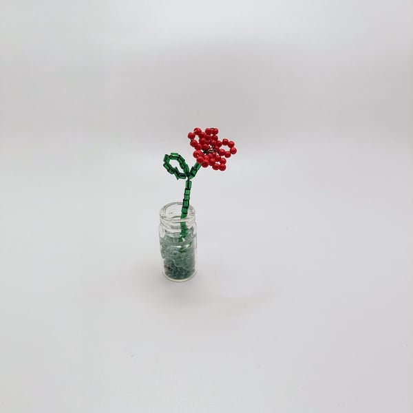 A unique and quirky poppy in a vase miniature remembrance brooch pin