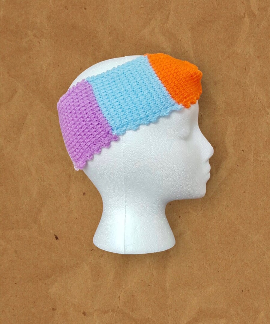 Ladies crochet headband (ear warmer). Size 8.5” by 3.5”. Multicoloured.