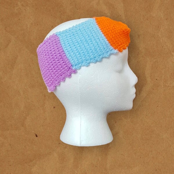 Ladies crochet headband (ear warmer). Size 8.5” by 3.5”. Multicoloured.