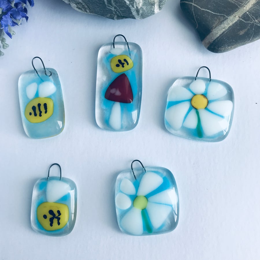 Fused glass sun catchers of bees and flowers