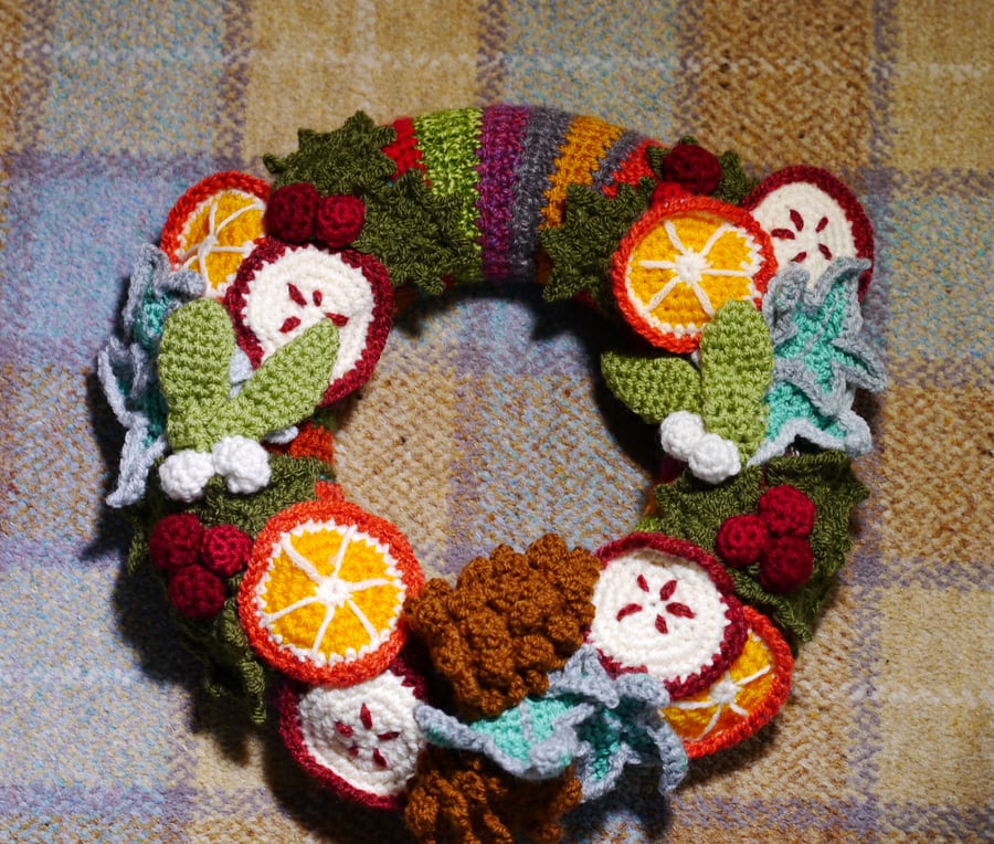 Winter Harvest Crochet Wreath, holly, ivy, pinecones, fruit. 