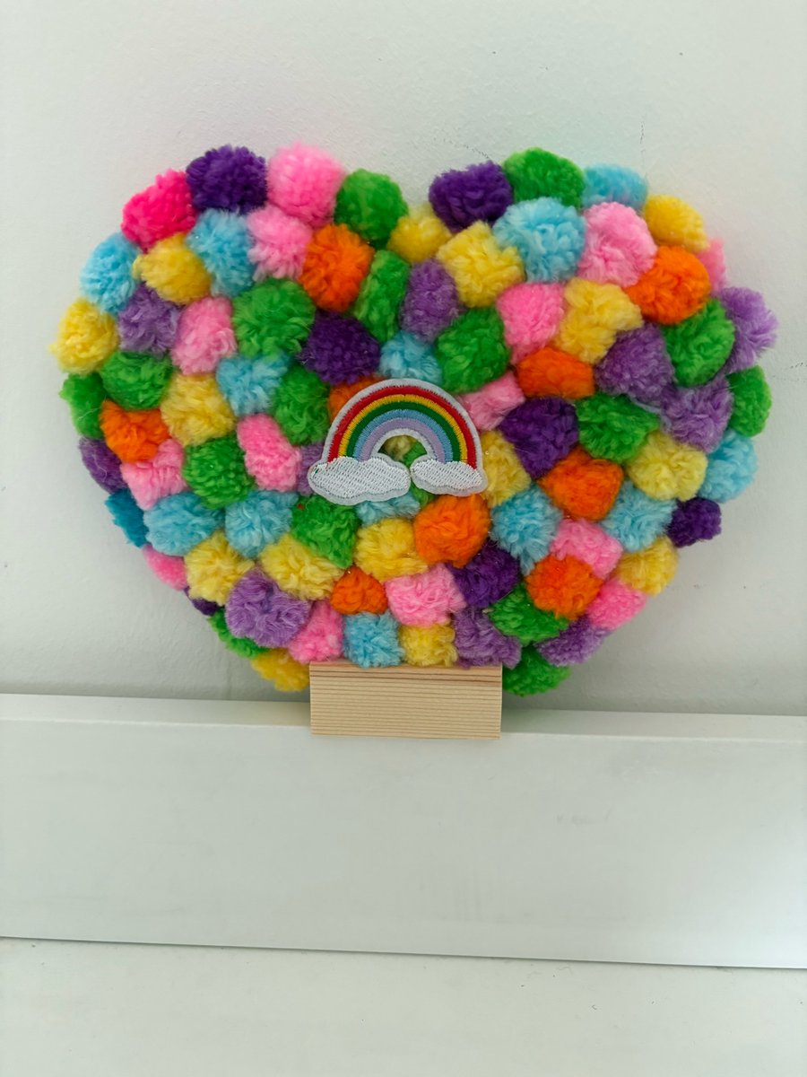 Pride decorated Pom Pom acrylic heart. 