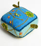 Turquoise felt half cube pincushion with almond blossom embroidery