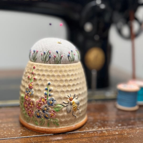 Pin cushion in an old honey pot embroidered flowers and bee