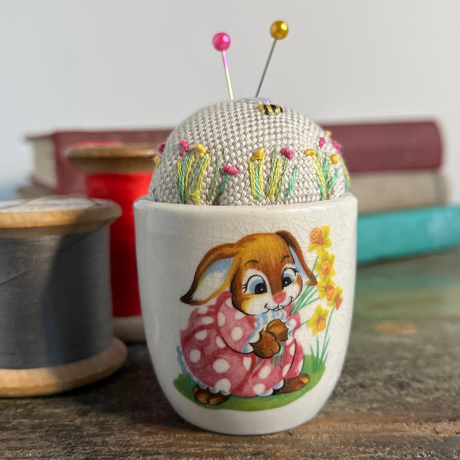 Pin cushion in vintage Easter bunny egg cup embroidered flowers and bee