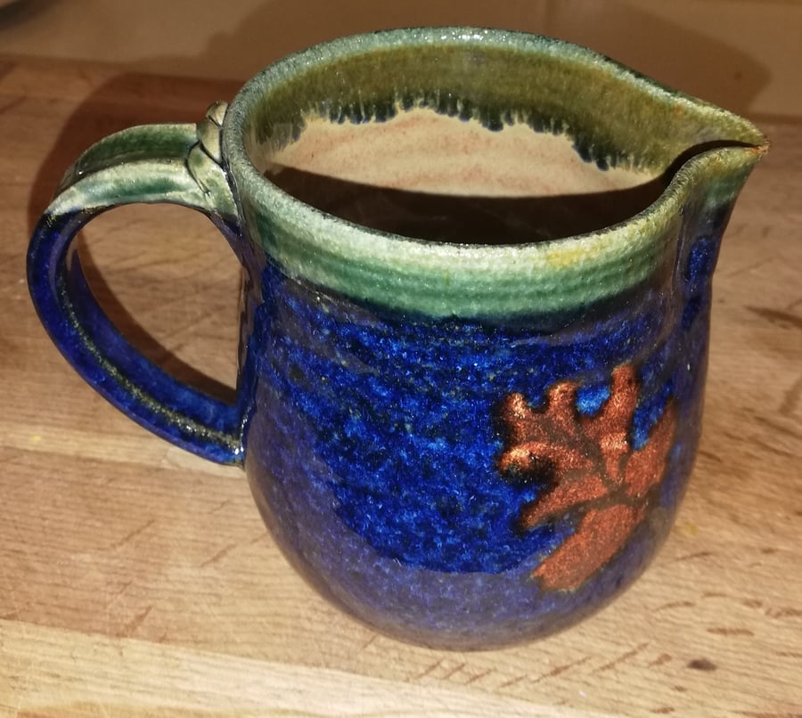 Oak leaf decorated stoneware blue jug