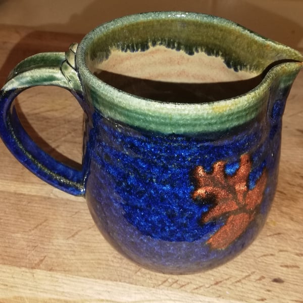 Oak leaf decorated stoneware blue jug