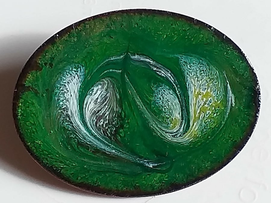 enamelled brooch - oval, scrolled white, gold and purple on green over clear