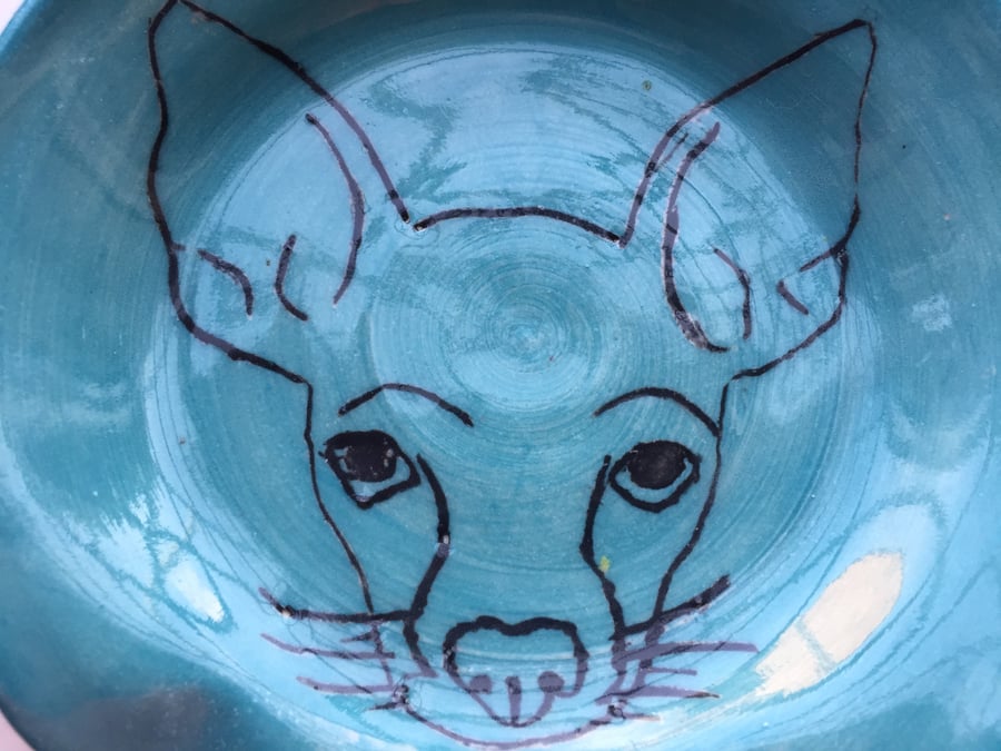 Spoon rest adorned by a Chihuahua. 