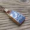 Worn pottery pendant set in aged copper bezel