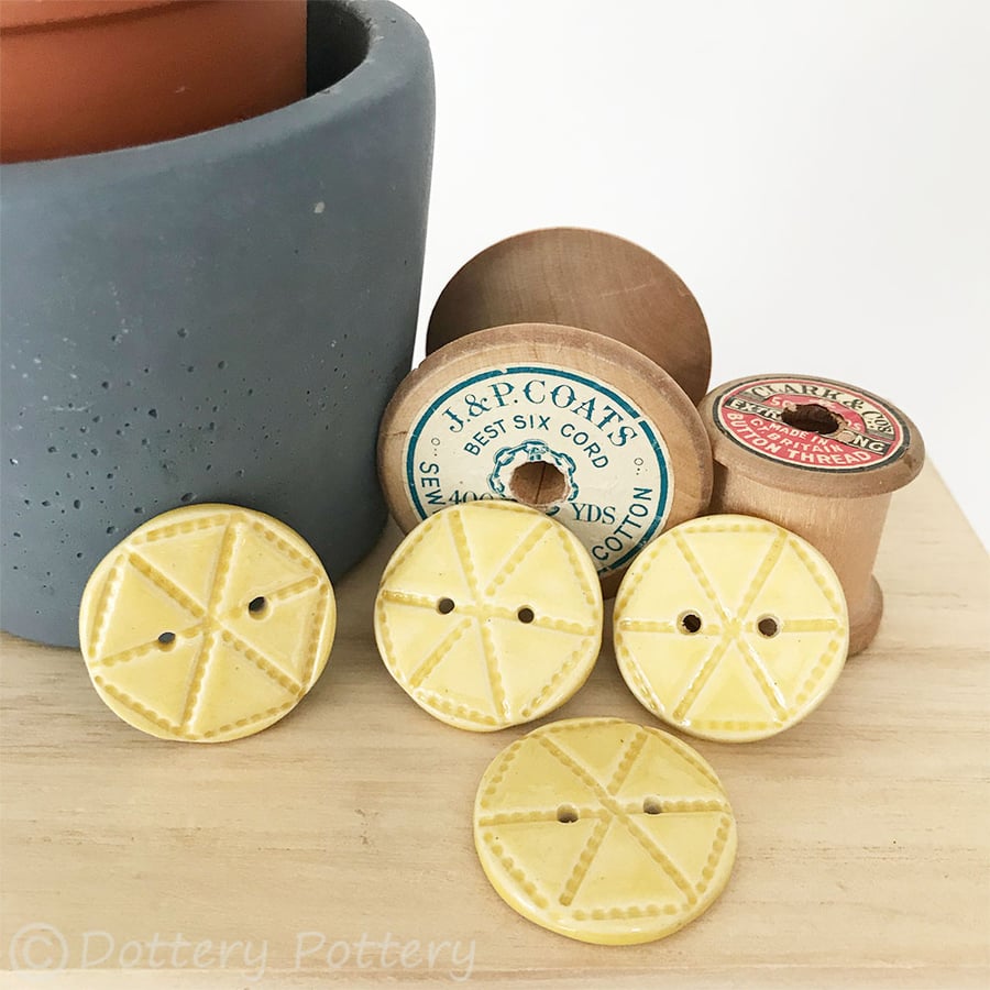 Set of four bright yellow ceramic handmade buttons