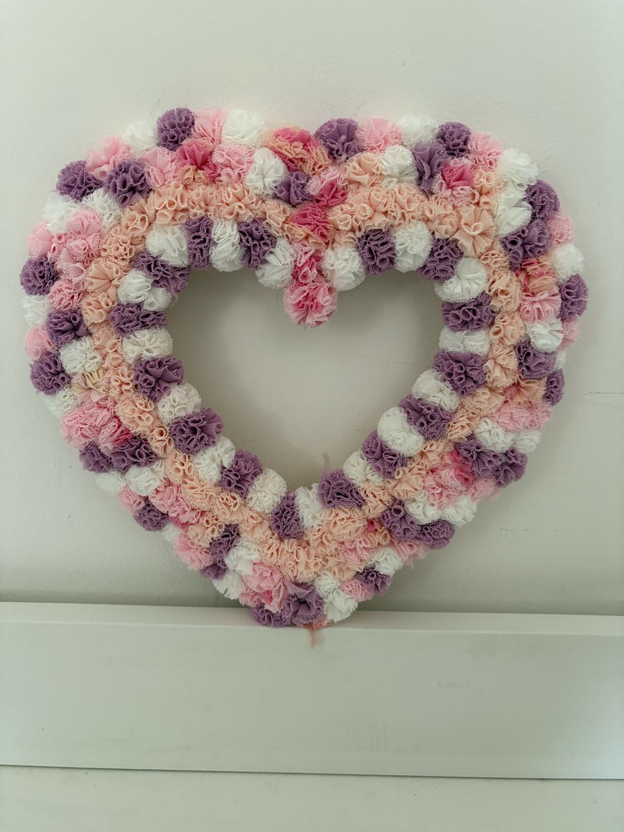 Pretty scrunchy pinks and lilac Pom Pom decorated wood heart. 
