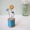 Clay Flowers and Bee on a Vintage Bobbin