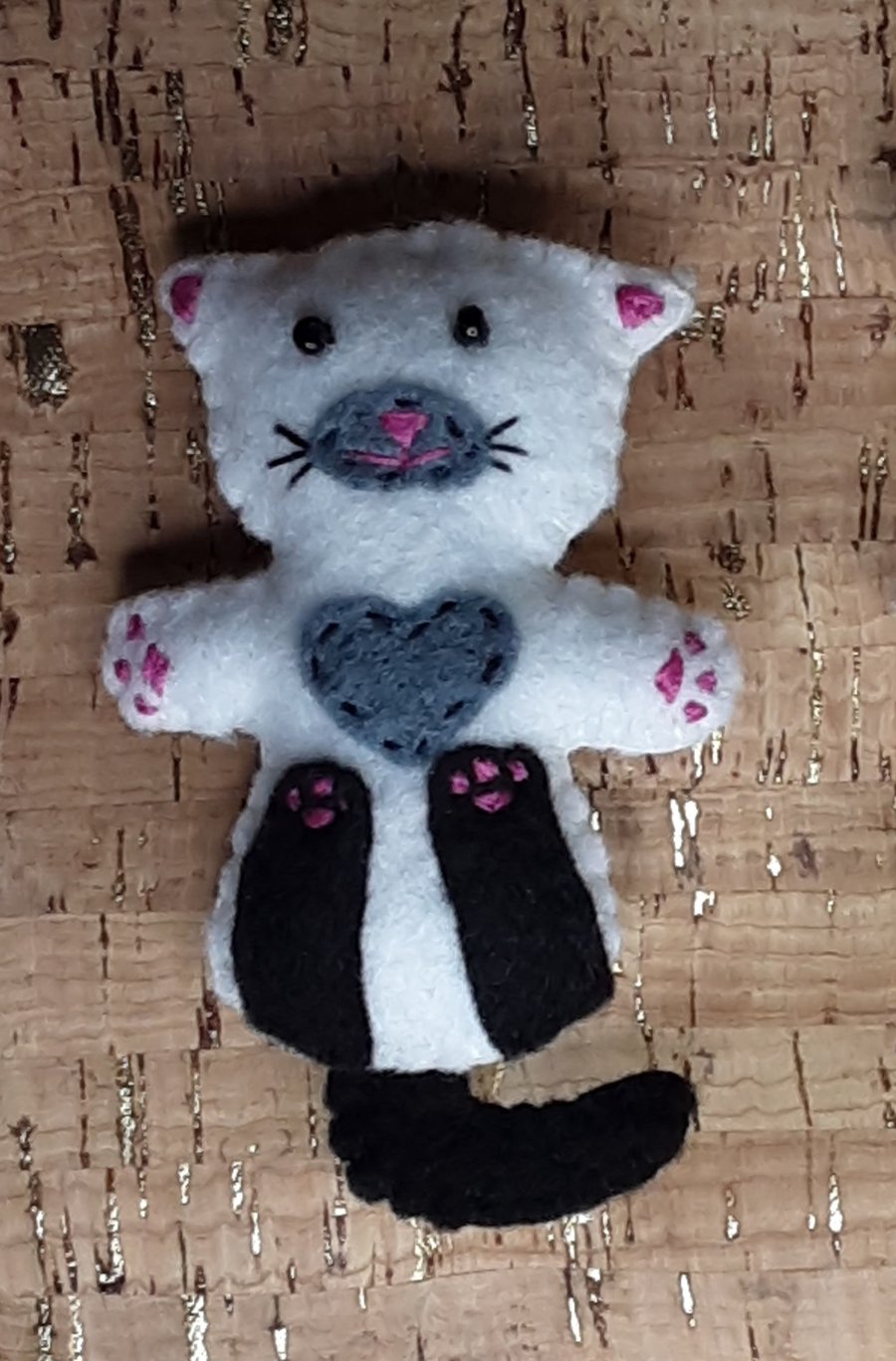 Cat on back White Felt Brooch with black legs, tail, grey chest & muzzle.