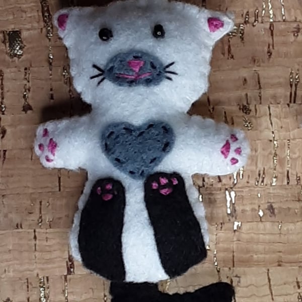 Cat on back White Felt Brooch with black legs, tail, grey chest & muzzle.