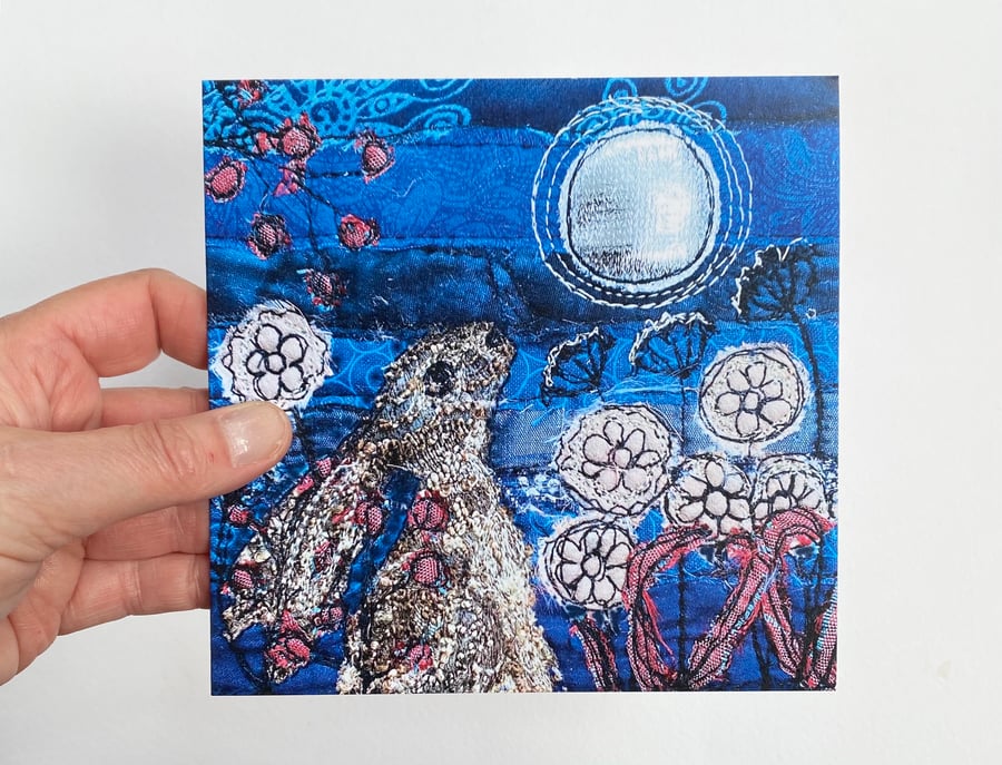 Hare in flower garden gazing at the full moon printed card. 
