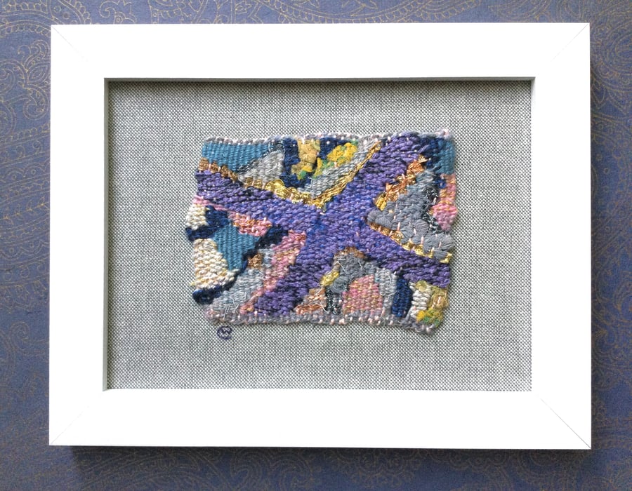 Framed handwoven tapestry weaving, textiles in purple, grey, pink and yellow