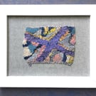 Framed handwoven tapestry weaving, textiles in purple, grey, pink and yellow