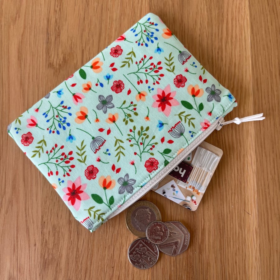 Small zipped fabric coin purse, pouch, in fun floral print on pale green cotton