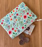 Small zipped fabric coin purse, pouch, in fun floral print on pale green cotton