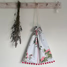 Chinese Flowers reclaimed cotton drawstring bag with pompoms and spotty lining