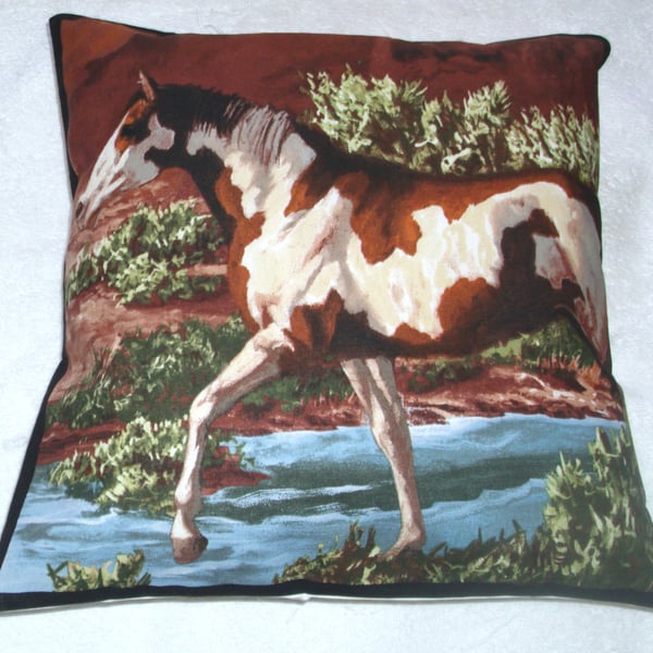 A beautiful brown  and white horse stepping through a stream cushion