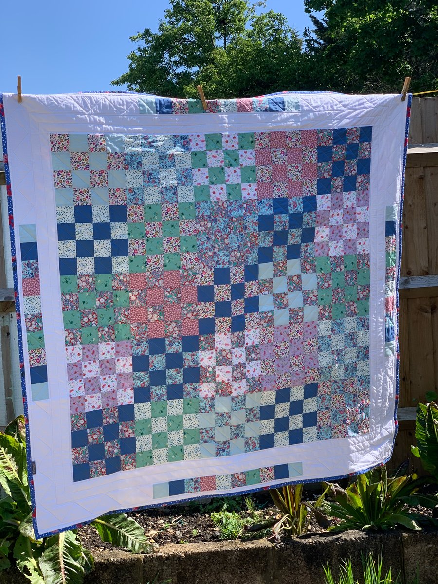 Floral, checkerboard patchwork quilt. 