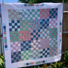 Floral, checkerboard patchwork quilt. 