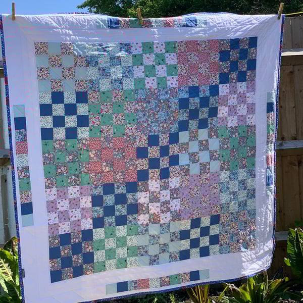 Floral, checkerboard patchwork quilt. 