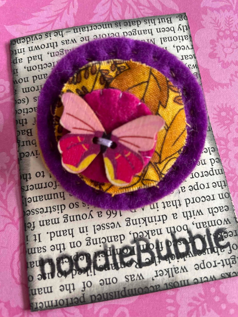 Pretty Pink Butterfly on purple felt brooch 