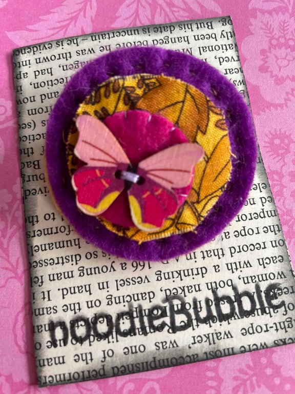 Pretty Pink Butterfly on purple felt brooch 