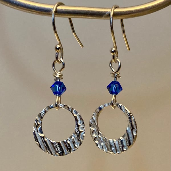 Circular dangly earrings with blue Swarovski crystal beads 