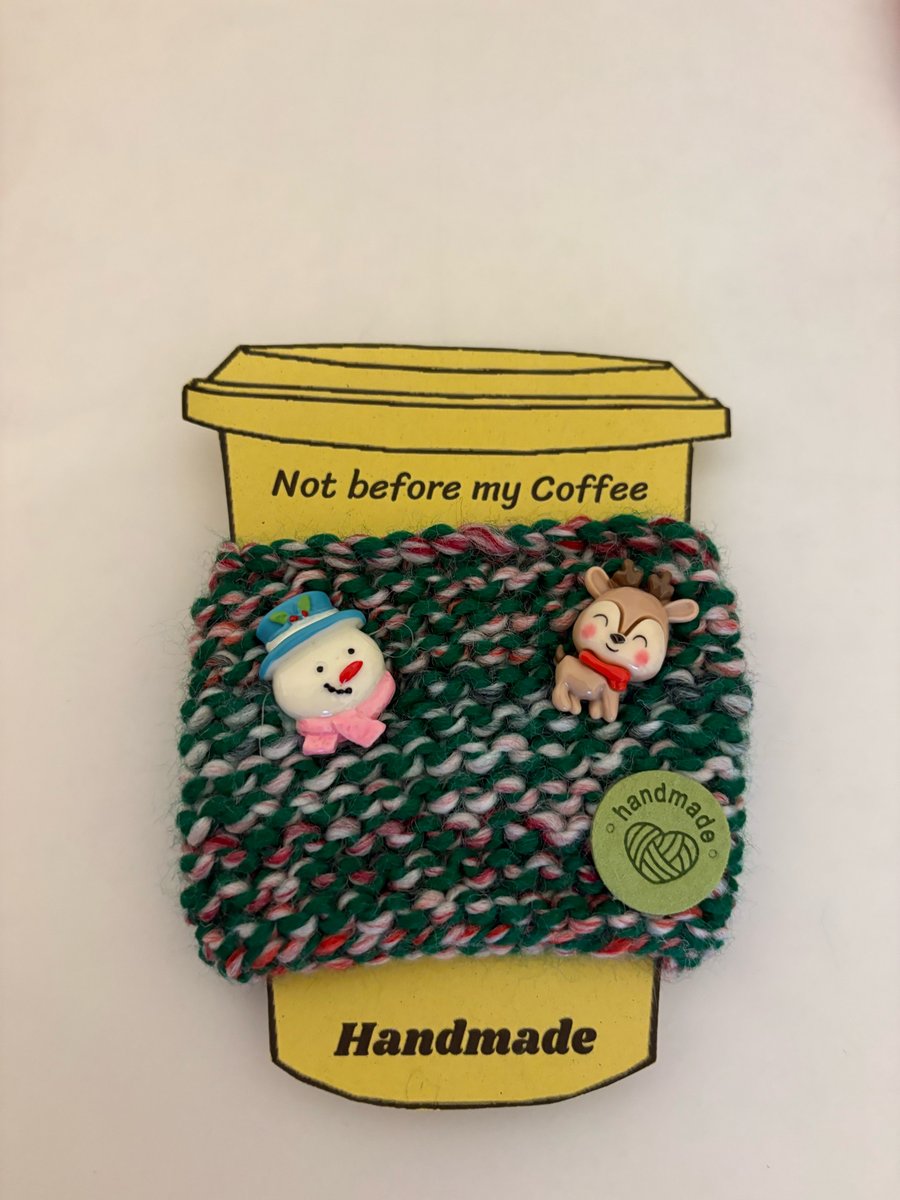 Hand knitted cup cosy with snowman and reindeer embellishments. 