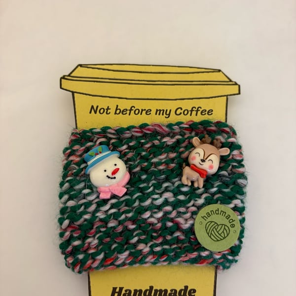 Hand knitted cup cosy with snowman and reindeer embellishments. 