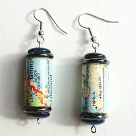 Paper beaded earrings with iridescent and blue beads made with a map of Norway