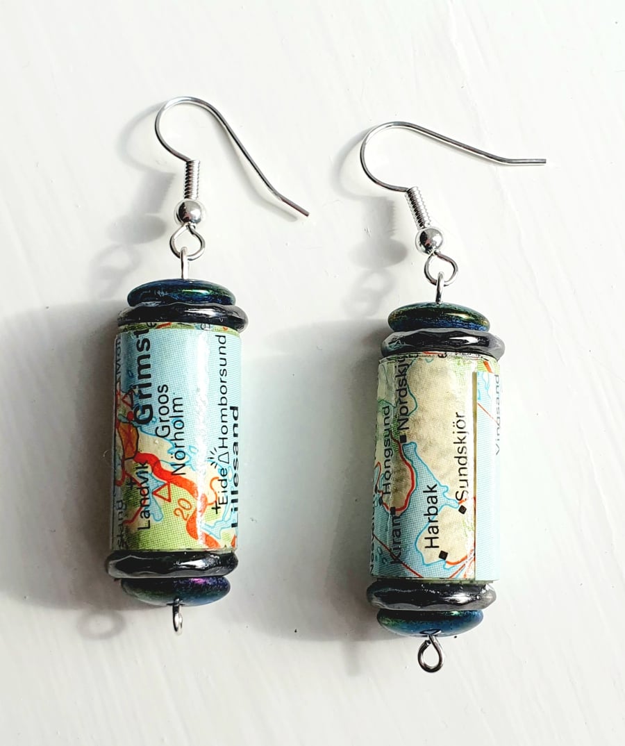 Paper beaded earrings with iridescent and blue beads made with a map of Norway