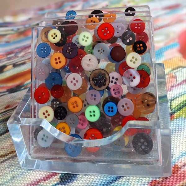 4 square coasters in a holder