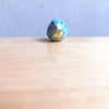 Tiny stand with Ukraine bird figurine miniature ceramic bird of hope