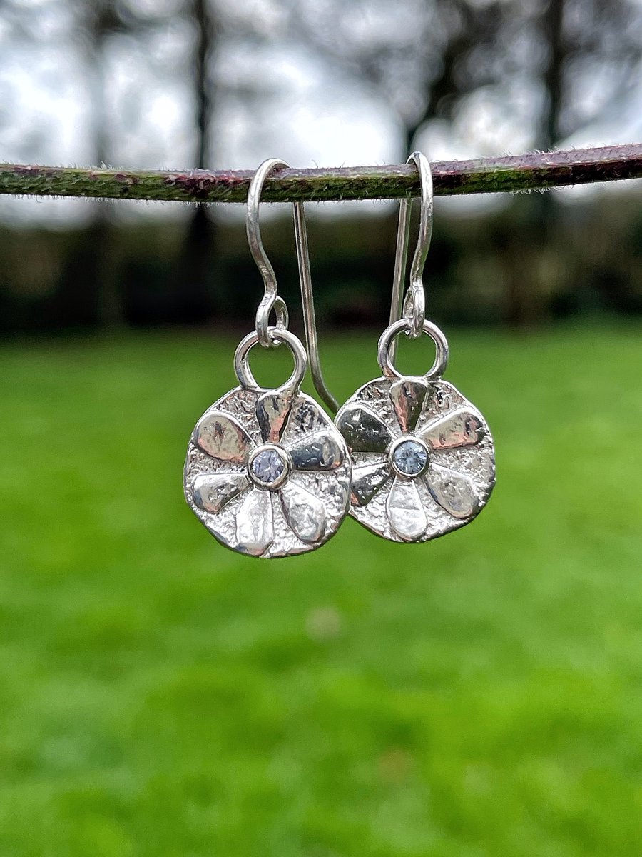 Small sterling silver flower earrings with faceted Ceylon sapphire centres
