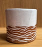 White ceramic planter with wave detail on speckled buff clay