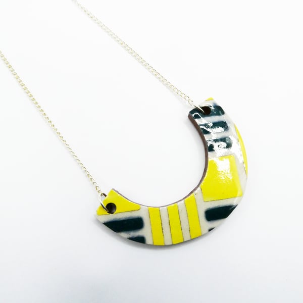 Ceramic arc pendant in white, yellow and blue green on a curb chain necklace