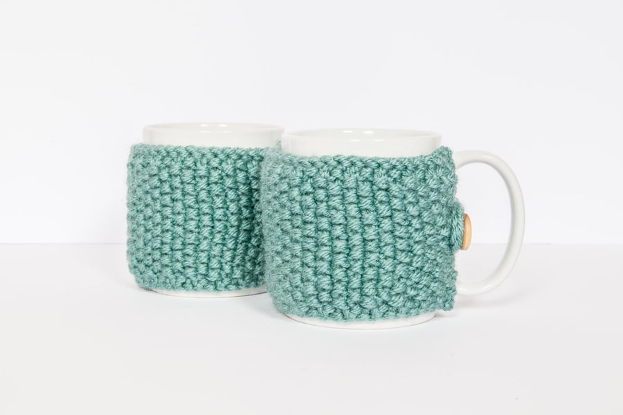 Pair of knitted mug cosies, cup cosy, coffee cosy in Teal. Coffee mug cosy