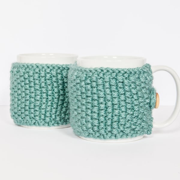 Pair of knitted mug cosies, cup cosy, coffee cosy in Teal. Coffee mug cosy