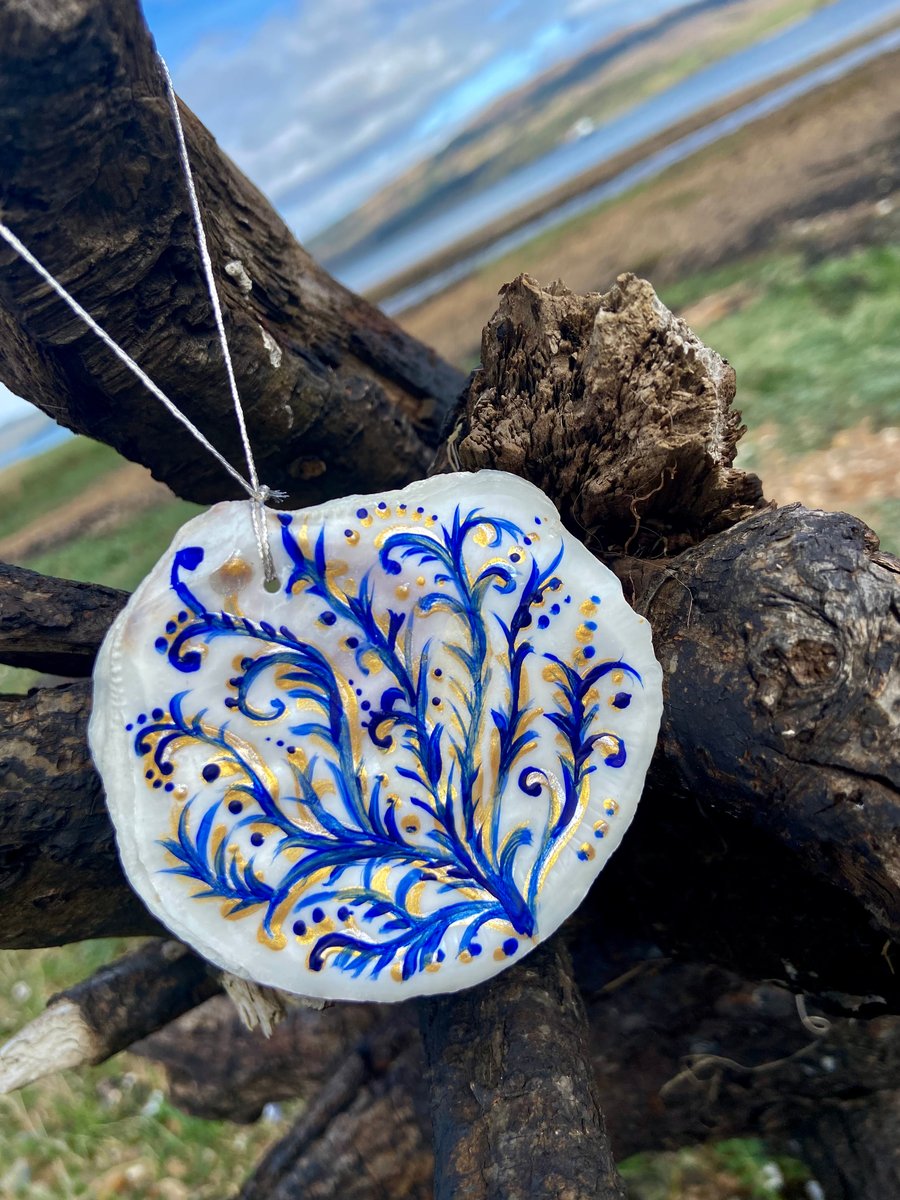 Hand painted oyster shell from an Argyll beach. With a beaded hanger.